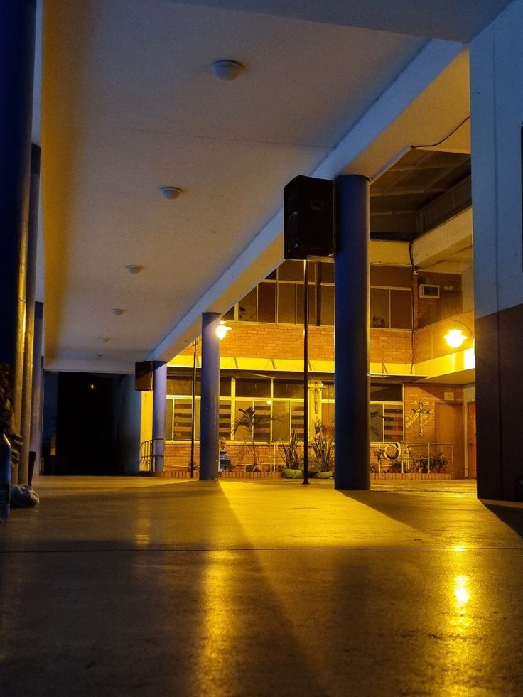 an empty parking lot at night with lights on