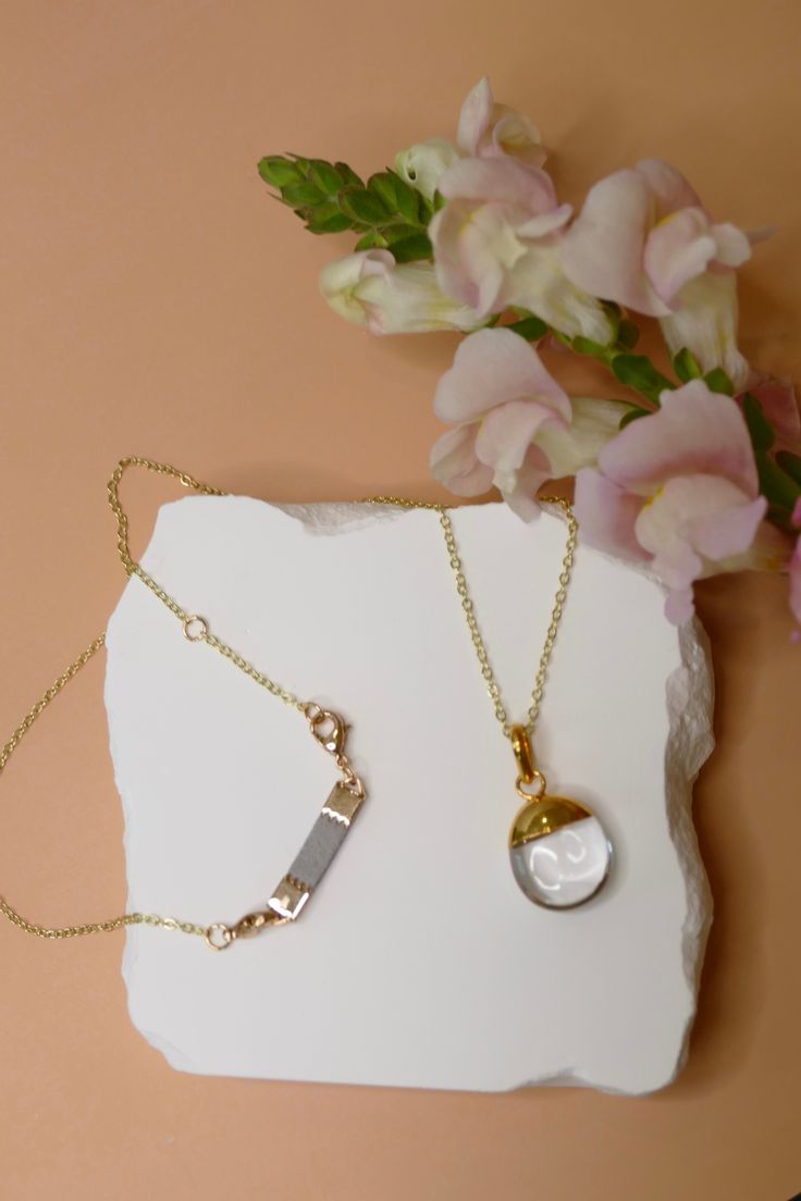 Polished Clear Quartz Stone DETAILS: Polished Clear Quartz Stone Jewelry Gold or Silver Plated Brass necklace chain 18" chain with 2" extender Adjustable in 1" increments: 18" - 20" Dainty diffuser piece for diffusing essential oils which can be removed if desired Unique faux suede material will diffuse essential oils for hours Wipe necklace clean after wearing to preserve the life of your jewelry Please keep dry and remove when bathing or swimming Hypoallergenic Round Pendant Necklace For Her, Gold Necklaces With Delicate Chain For Keepsake, Gold Necklace With Delicate Chain For Keepsake, Keepsake Gold Necklace With Delicate Chain, Adjustable Chain Necklace With Round Pendant As Gift, Adjustable Round Pendant Chain Necklace As Gift, White Chain Necklace With Round Pendant And Adjustable Chain, White Round Pendant Necklace With Cable Chain, White Necklace With Round Pendant And Cable Chain