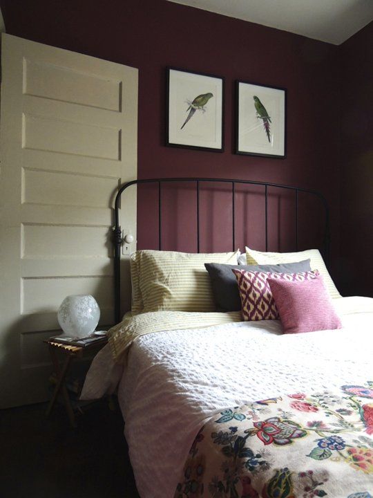 a bed with two framed pictures on the wall