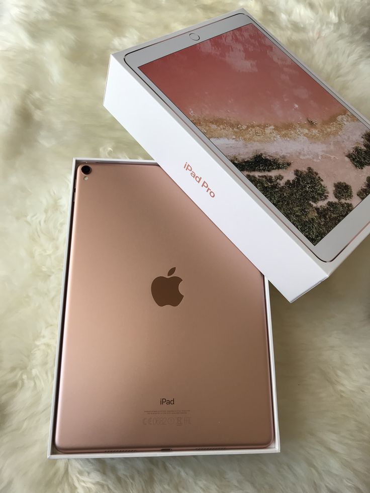 an apple ipad in its box on a white furnishing area with the lid open