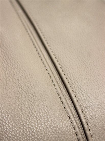 closeup of the stitchs on a white leather material