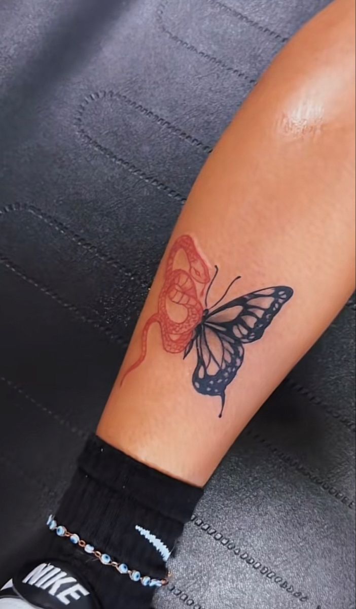 a person with a butterfly tattoo on their arm