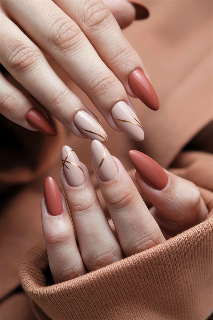 Embrace the season with these chic fall nail ideas that exude a sophisticated yet understated vibe. This Autumn simple design features a warm terracotta base adorned with delicate leaf patterns in muted gold and rust. Perfect for any occasion, these nails capture the essence of fall while remaining effortlessly stylish. Elevate your nail game this autumn with this stunning look! #FallNailIdeas #AutumnNails #NailArt #SeasonalStyle Nails To Match Rust Color Dress, Rust Color Nails Designs, Terracotta Nails Designs, Rust Nails Design, Earth Tone Nails Designs, Simple Fall Nail Ideas, Terracotta Nails, Rust Nails, Cinnamon Nails