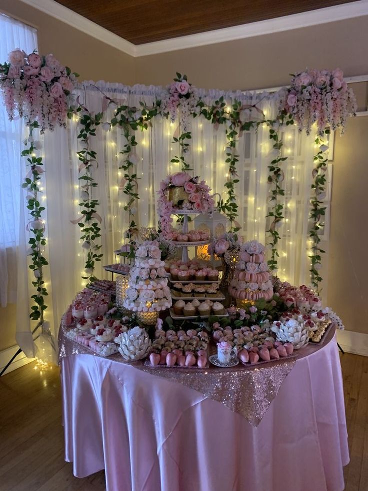 a table topped with lots of cakes and cupcakes