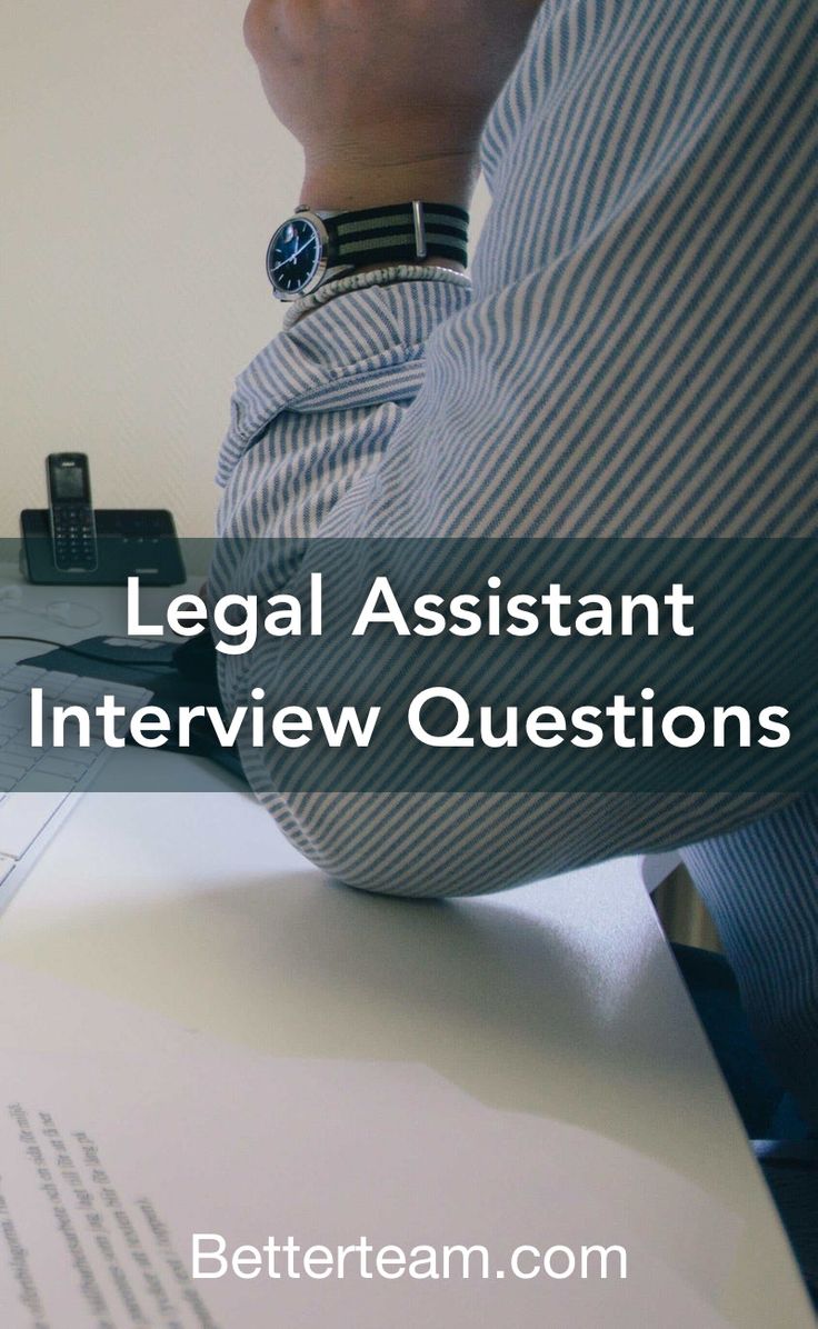 a person sitting at a desk with their hand on top of the paper that says legal assistant interview questions