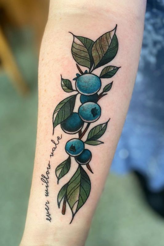 a tattoo with blueberries and leaves on the arm that says, i love you