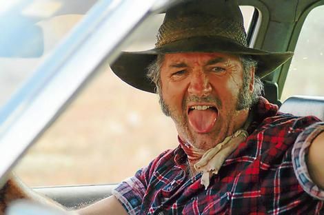 a man with his mouth open sitting in the driver's seat of a car