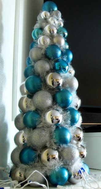 a silver and blue christmas tree with ornaments