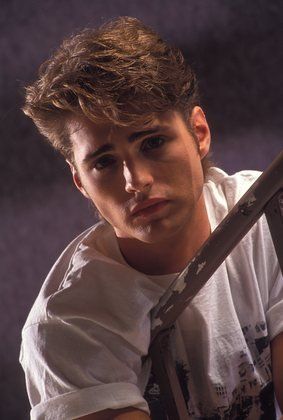 a young man holding a large knife in his hands