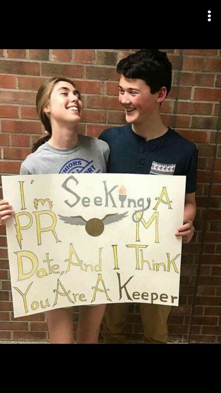 two people standing next to each other holding a sign that says i'm seeking a prm date and i think you are a keeper