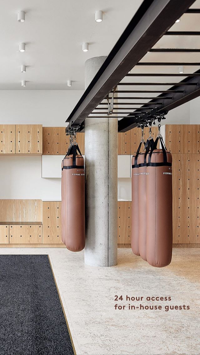 there are two boxing bags hanging from the ceiling