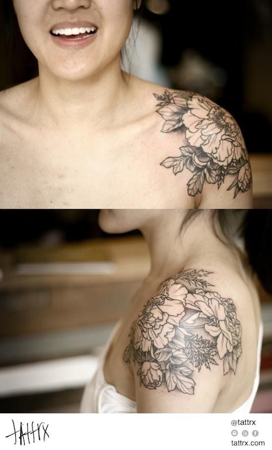 a woman with a flower tattoo on her shoulder and chest, both showing the same amount of tattoos