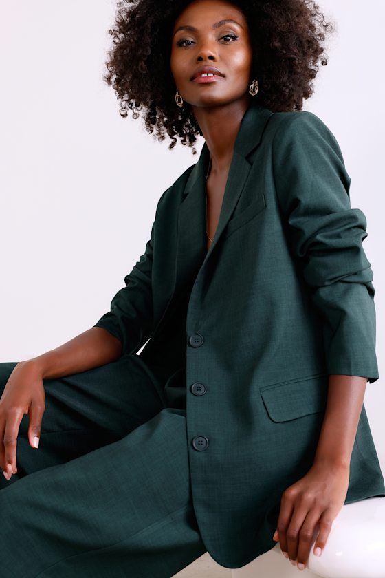 From brunch to the boardroom, prepare for compliments along the way in the Lulus Bold Poise Dark Green Button-Front Blazer! Lightweight stretch-woven fabric shapes this chic blazer with a collared neckline, notched lapels, and long sleeves with lightly padded shoulders and button cuffs. The slightly oversized bodice features a trio of functional buttons at the center, accompanied by two, functional flap pockets. Kick pleat at back. Pair with the matching pants for a complete look! Fit: This garm Tailored Button-up Blazer For Career, Green Blazer Dress For Work In Fall, Green Single Breasted Blazer Dress For Workwear, Green Blazer With Hidden Buttons For Office, Green Office Blazer With Hidden Button Closure, Modern Office Blazer With Button Closure, Green Notch Lapel Blazer For Work, Chic Green Blazer For Business, Chic Green Single-button Blazer