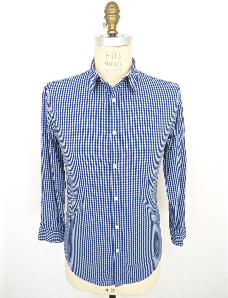 "\"Renaissance Man\" vintage dress shirt by DKNY in blue-on-light-blue check patterned 100% cotton--Beautiful condition! SIZE: Tagged Men's Small MEASUREMENTS*: Shoulder: 17\" Chest (underarm to underarm): 19\" Waist: 18\" Length (base of back collar to back hem): 29\" Sleeve (outside shoulder seam to sleeve): 23\" Neck: 15-15.5\" *All measurements taken seam-to-seam lying flat and should be doubled where applicable, i.e., chest, waist. Label: DKNY Jeans Color: Blue & Light Blue (Check) with Classic Fitted Plaid Shirt, Classic Plaid Fitted Shirt, Plaid Fitted Classic Shirt, Business Casual Plaid Cotton Dress Shirt, Plaid Cotton Dress Shirt For Business Casual, Blue Fitted Shirt With Spread Collar, Slim Fit Plaid Cotton Shirt, Plaid Slim Fit Cotton Shirt, Blue Spread Collar Shirt For Daywear