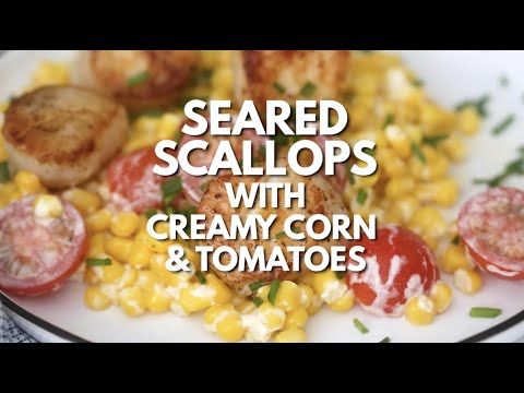 a white plate topped with corn, tomatoes and scallops on top of it