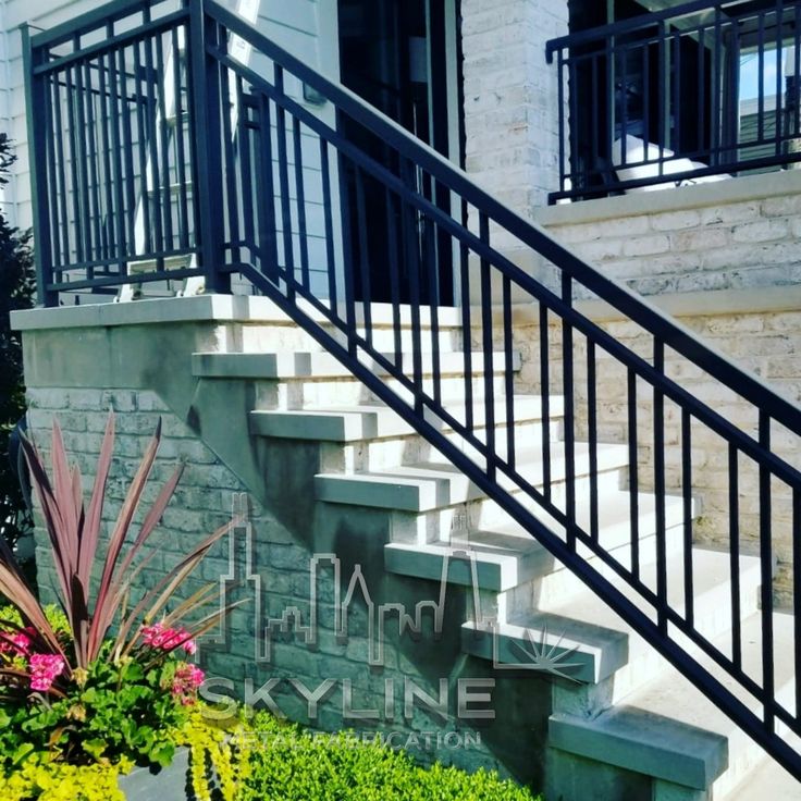 there is a planter with flowers in front of the stairs