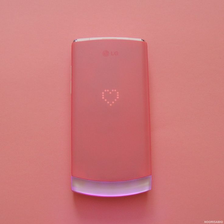 a pink cell phone with the number 0 on it's back side and an illuminated screen