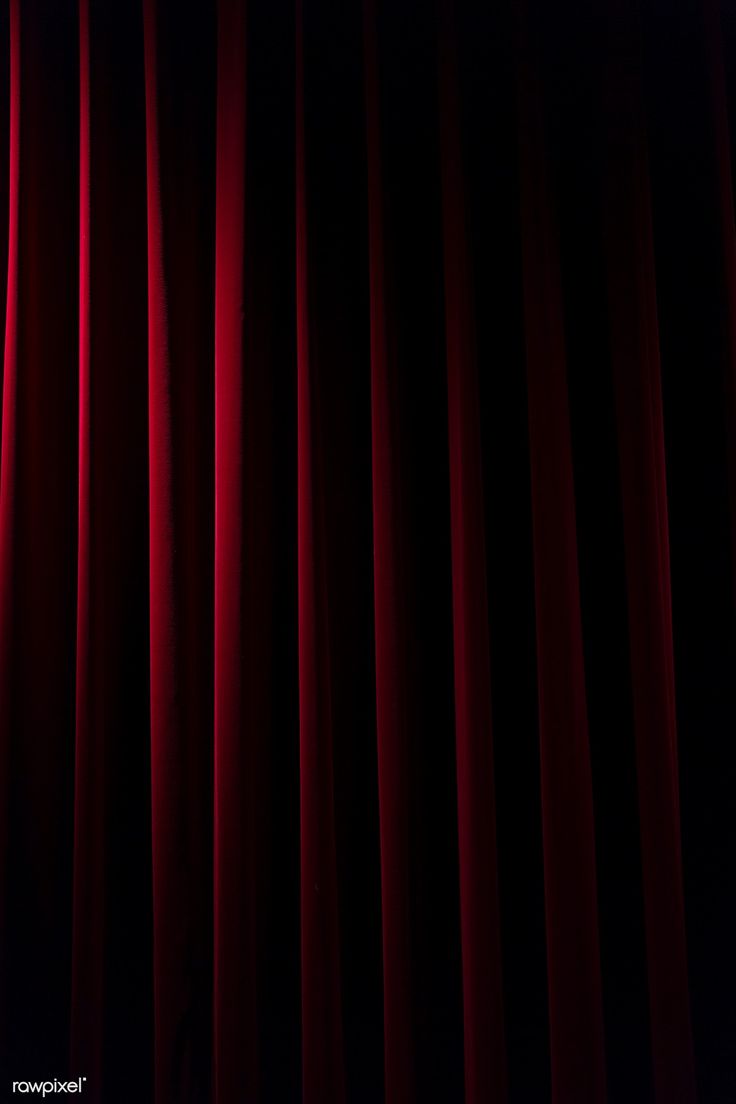 a red curtain that is open in the dark