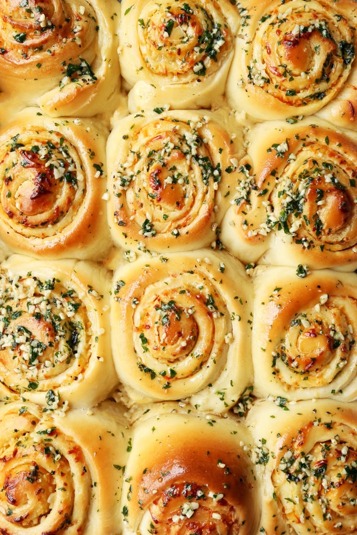 many rolls with cheese and herbs on top