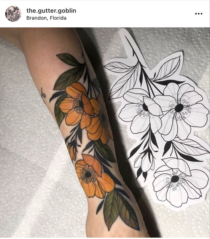 a woman's arm with flowers on it and an outline of a flower in the background