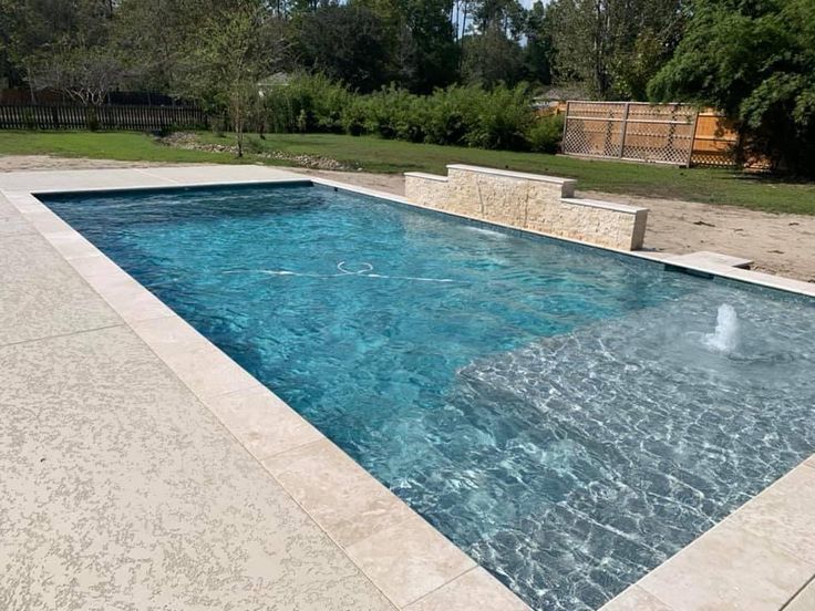 an empty swimming pool in the middle of a yard