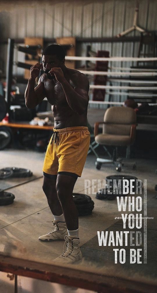 a man standing in a boxing ring with his hands to his face and the words, remember who you want to be