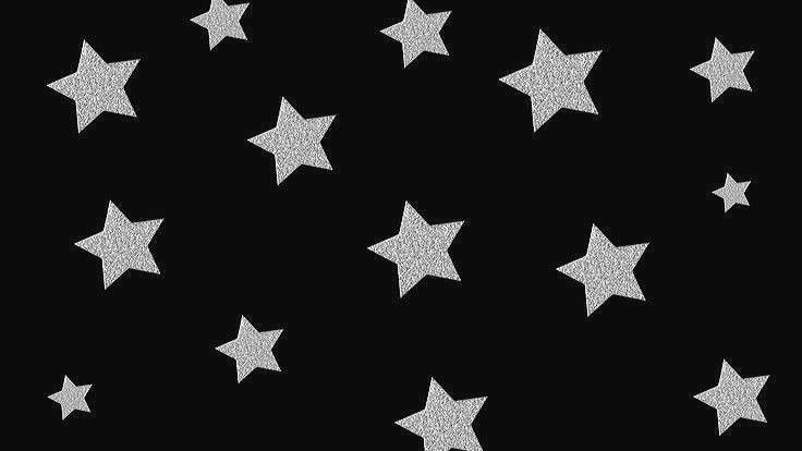 silver glitter stars on a black background