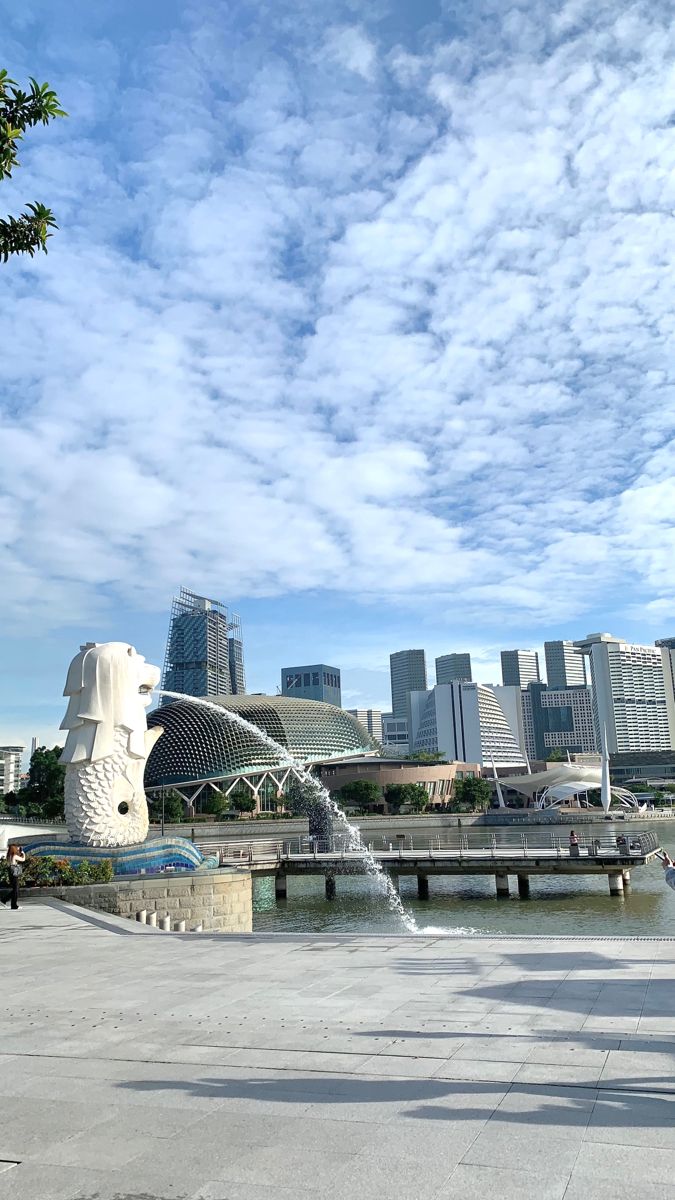 there is a fountain in front of the city