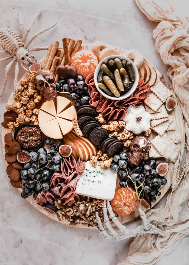 a platter filled with different types of food and nuts on top of a table