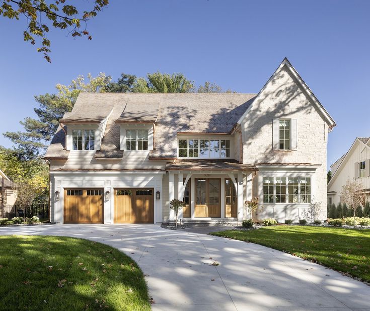 a large white house with two garage doors