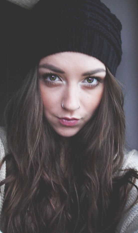 a woman with long hair wearing a beanie