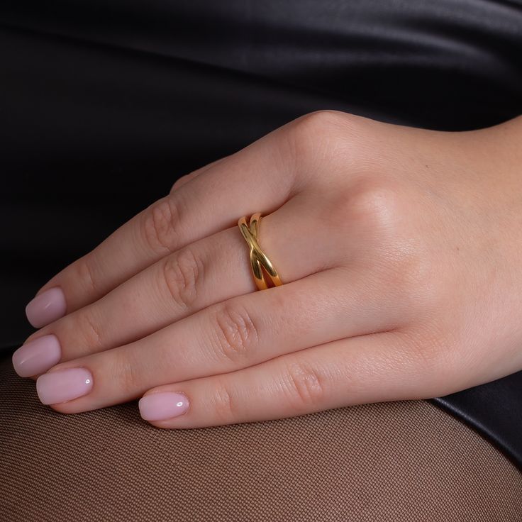 a woman's hand with a gold ring on it