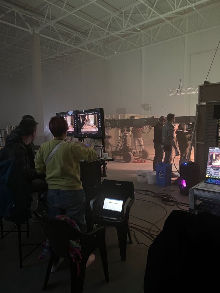 several people are playing video games on their laptops in a large room with chairs