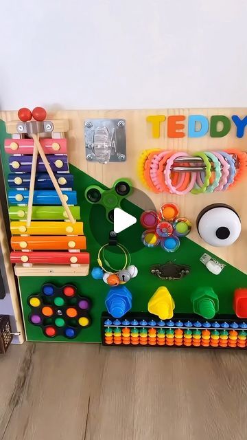 a child's play area with toys and magnets on the wall in front of it