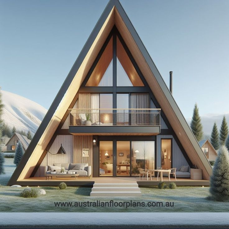 a house in the middle of a snowy field with trees and snow covered mountains behind it