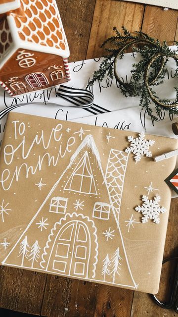 some wrapping paper and christmas decorations on a wooden table with scissors, ornaments and other items