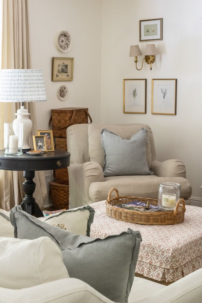 a living room filled with furniture and pictures on the wall