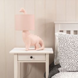 a white cat lamp sitting on top of a night stand next to a small bed