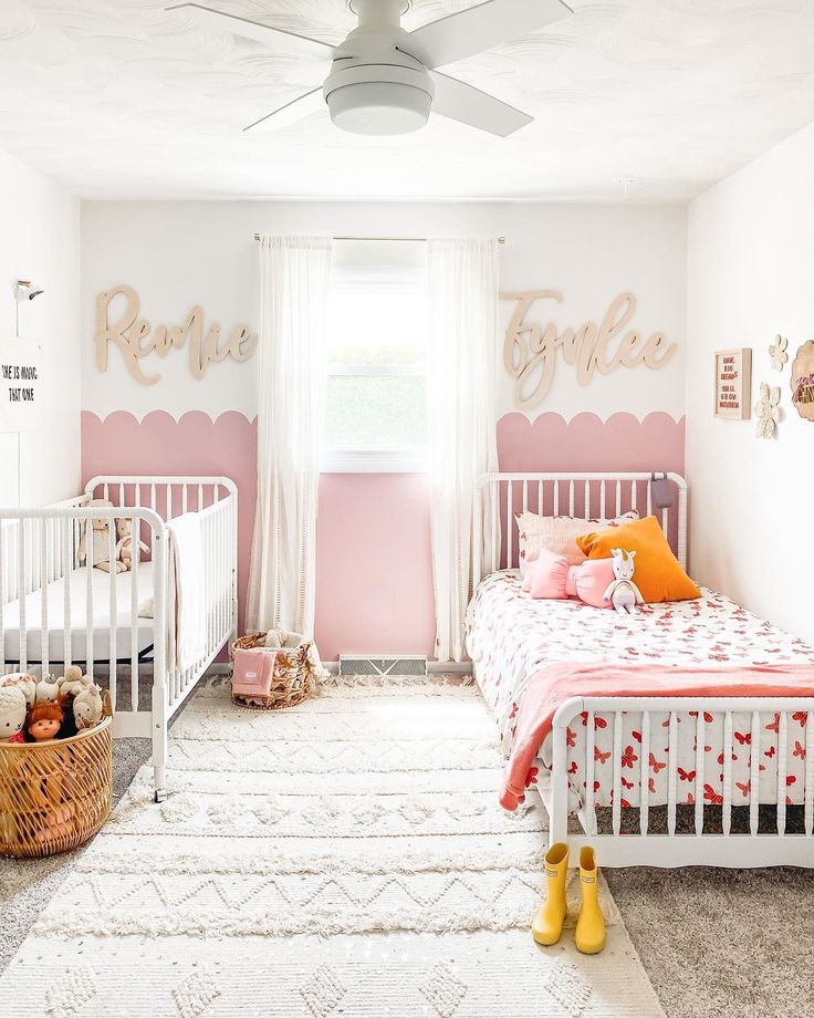 a baby's room with pink and white decor