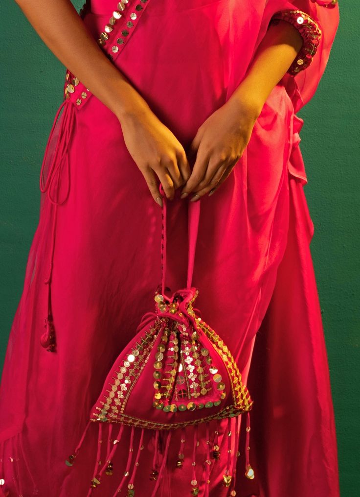 This elegant Pink Embroidered and Handcrafted Potli is a stunning accessory, crafted from luxurious satin and adorned with intricate hand-embroidered lace. The rich detailing includes mirror-like sequins and meticulously designed borders, offering a perfect blend of tradition and contemporary style. Ideal for weddings or festive outfits, this potli adds a touch of sophistication. This beautifully embellished bag ensures a fully styled, elegant look. Carry your essentials in style with this timeless piece. Composition : SatinCare: Dry Clean Only and Vacuum Storage This product can be customized for sleeves, blouse length and neckline Delivery : 2-4 weeks as the product is hand crafted. Check Size Guide or choose MySize for free customisation (All Sizes above XL can be made at 15% additional Stylish Drapes, Indian Wedding Wear, Blouse Length, Wedding Wear, Embroidered Lace, Festival Outfits, Timeless Pieces, Indian Wedding, Contemporary Style