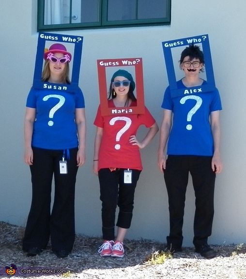 three people wearing funny shirts with question marks on their heads and one woman holding up a sign that says guess who?