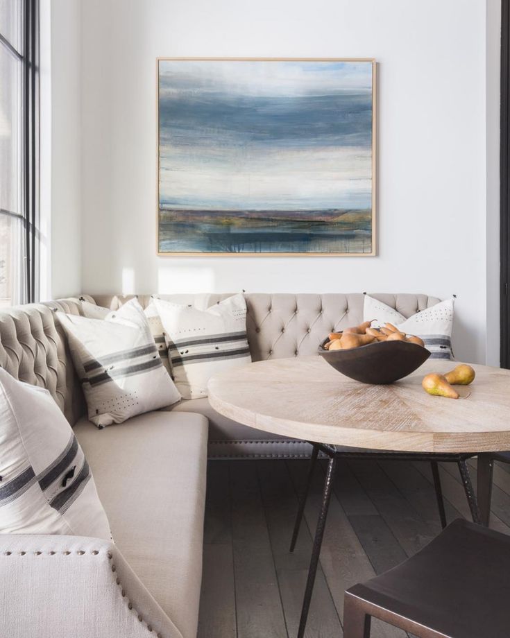 a table with fruit on it in front of a couch