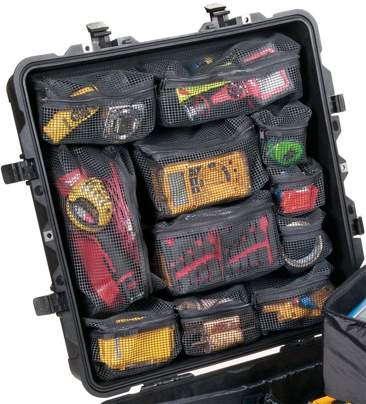 an open black case filled with lots of different types of bags and items in it