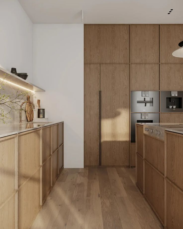 a modern kitchen with wooden cabinets and stainless steel appliances, along with hardwood flooring