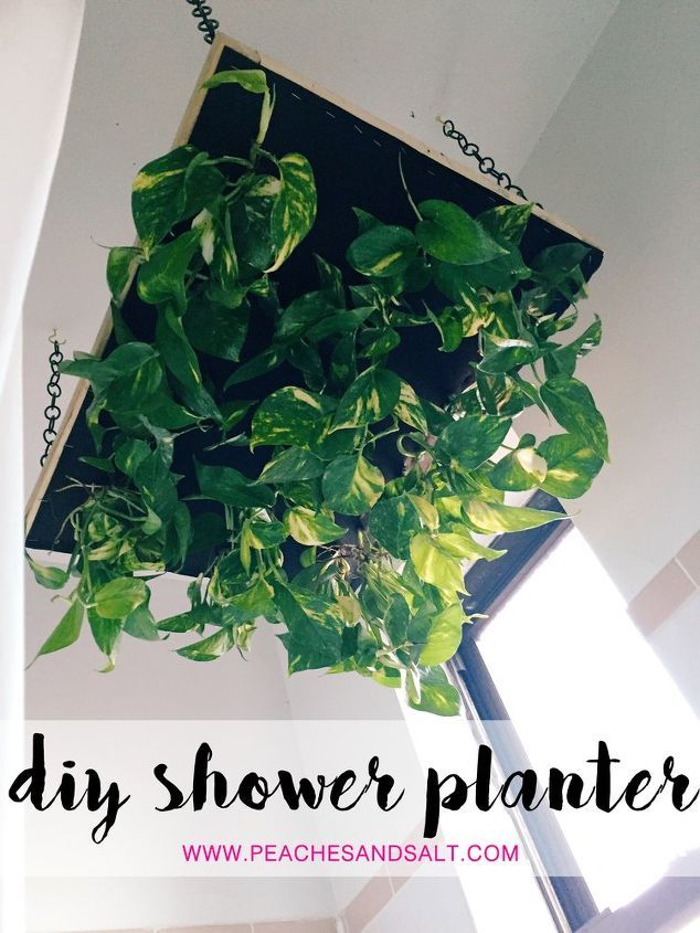 a hanging planter filled with green plants in the corner of a room that says diy shower planter