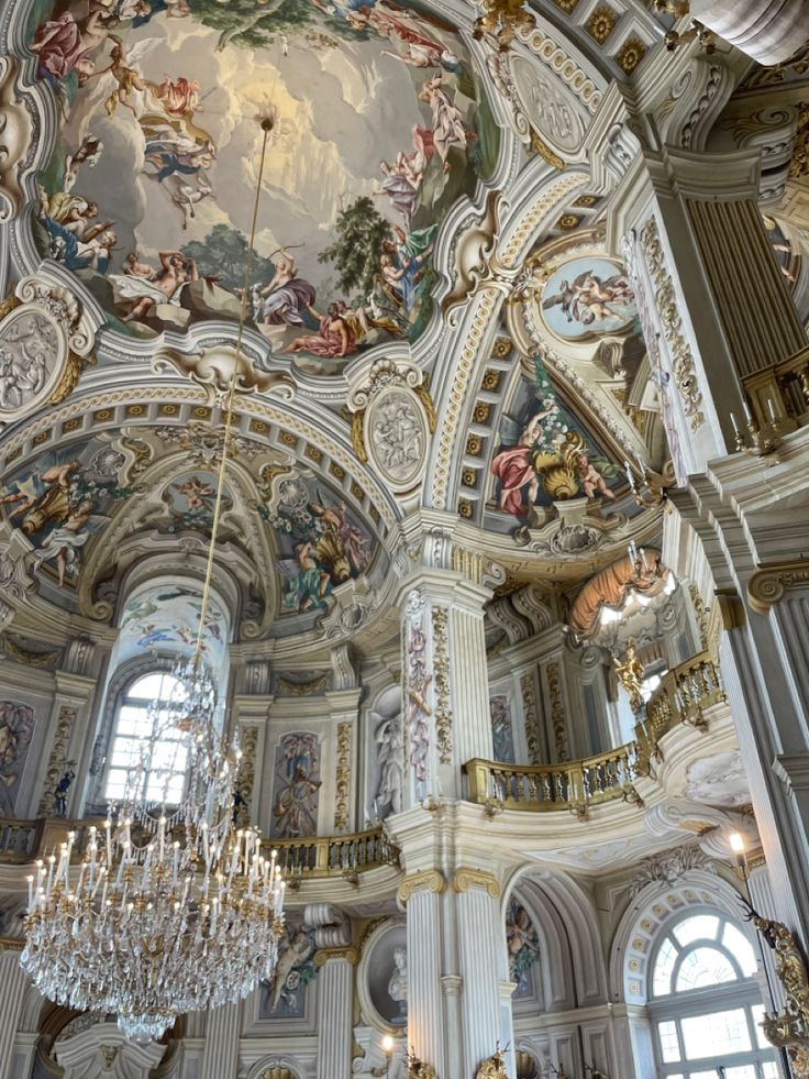 an ornate ceiling with chandeliers and paintings on it