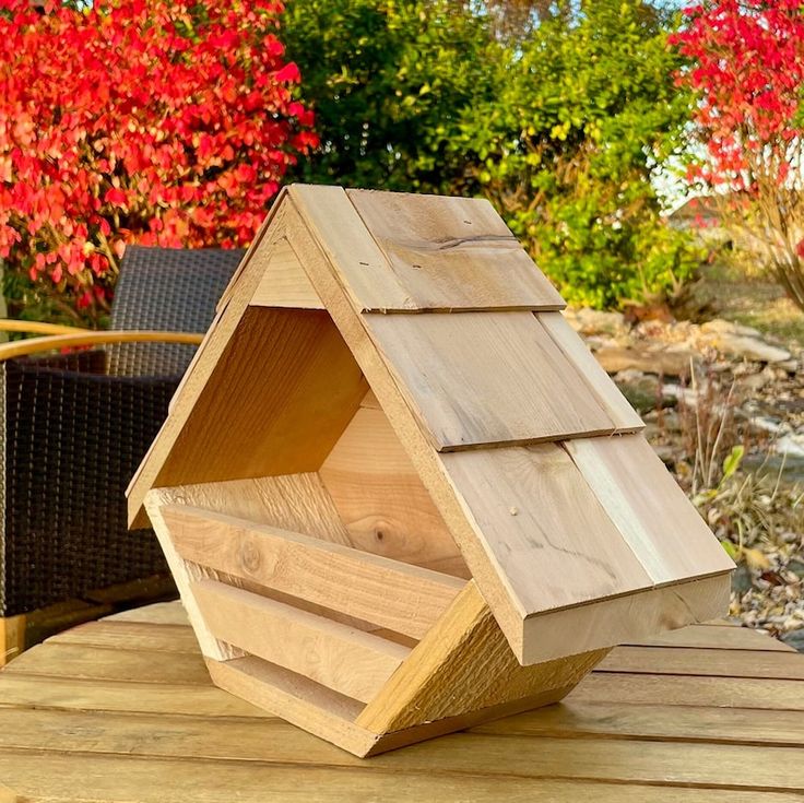 a bird house sitting on top of a wooden table