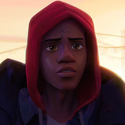 a man in a hoodie stares into the distance with an orange sky behind him