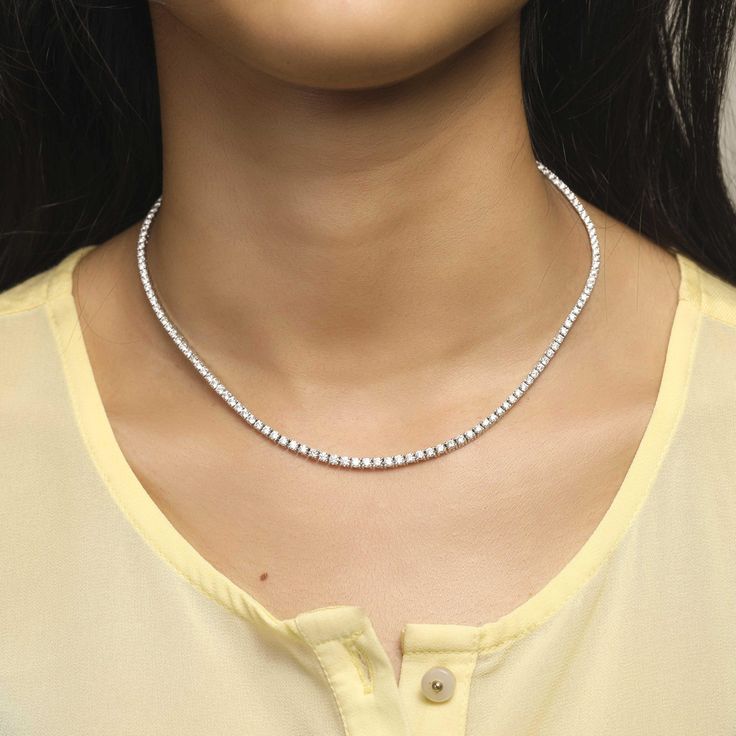 This elegant 4-Prong Tennis Necklace will be sure to add a touch of class to any outfit. Crafted with diamond-like 4-prong stones, this statement piece is sure to shine. With premium quality metal and an understated luminance, this necklace is a timeless piece perfect for both day and night. Dazzling Diamond-cut Tennis Necklace, Elegant Crystal Tennis Necklace With Prong Setting, Classic White Crystal Tennis Necklace, Fine Jewelry Diamond Accents Tennis Necklace, Crystal Tennis Necklace With Diamond Cut, Classic Crystal Tennis Necklace, Diamond White Solitaire Necklace For Formal Occasions, Classic White Tennis Necklace With Sparkling Stones, Anniversary Rhinestone Necklace With Diamond Accents