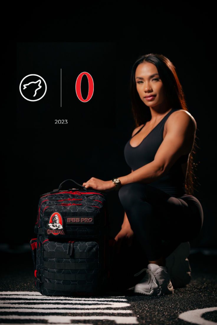 a woman sitting on the ground next to a luggage bag with an o logo above it